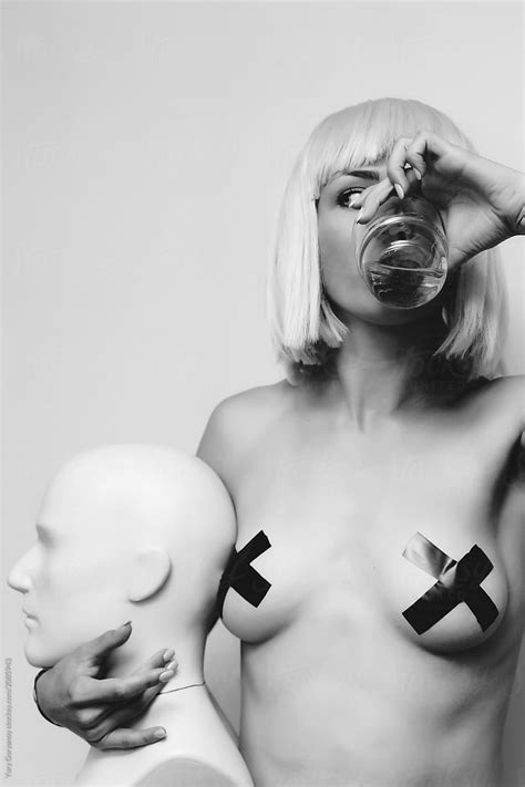 Portrait Of A Blonde With A Glass And A Mannequin By Stocksy Contributor Yury Goryanoy Stocksy