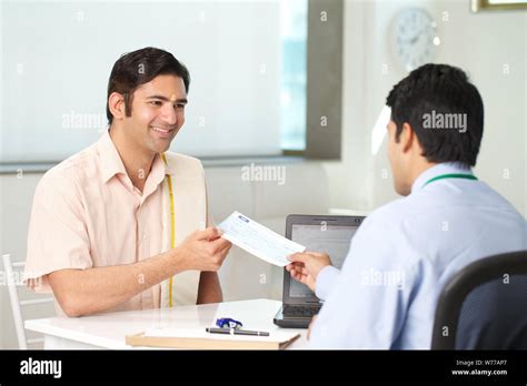South Indian Man Taking Cheque From Bank Manager As Loan Stock Photo
