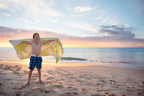 Swinging A Towel At The Beach At Sunset Porangela Lumsden