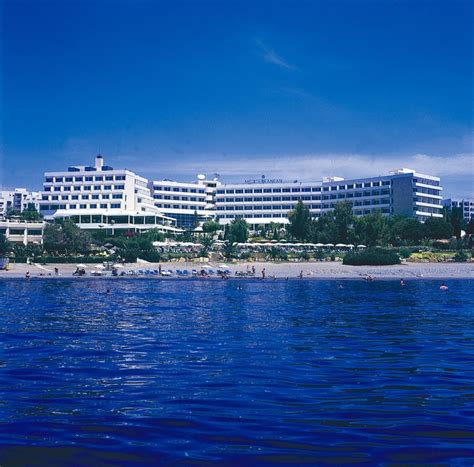 a large building sitting on top of a beach next to the ocean