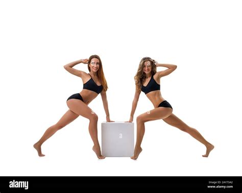 Two Sporty Girls Posing By Cube In Studio Stock Photo Alamy