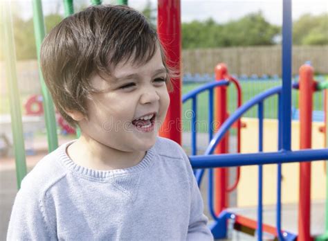 Portrait Of Cheerfull Little Boy Having Fun On Playground Outdoors