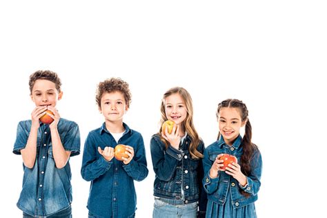 유토이미지 Four Children In Denim Clothes Eating Apples Isolated On White