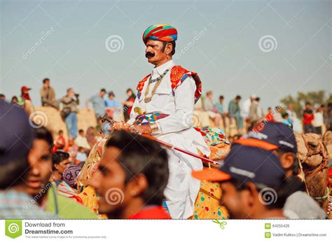 Camel Rider In Retro Indian Costume Drive Through The Crowd Of The