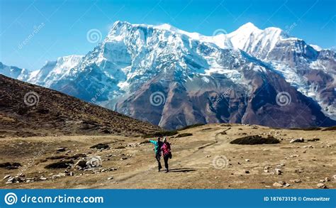ice lake a couple walking along a pathway with the view on annapurna chain stock image image