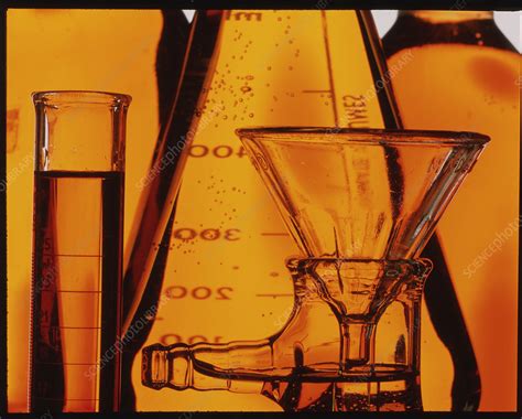 assorted laboratory glassware with golden solution stock image t875