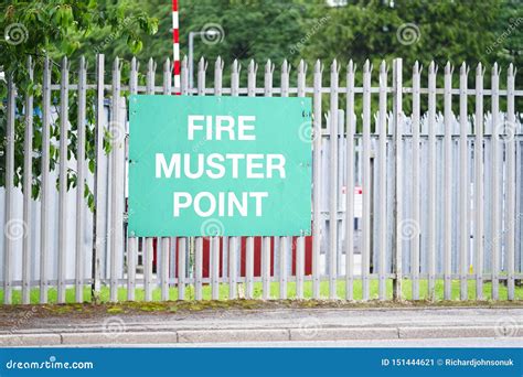 Fire Muster Assembly Point Sign At Workplace Car Park Fence Royalty