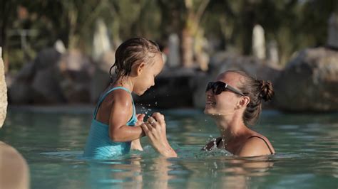 Happy Pretty Mother And Her Daughter Have A Fun In Swimming Pool Stock Video Footage 0009 Sbv