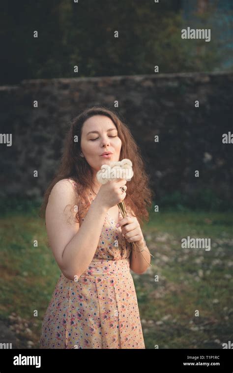 Cute Girl Playing With Blowball Stock Photo Alamy