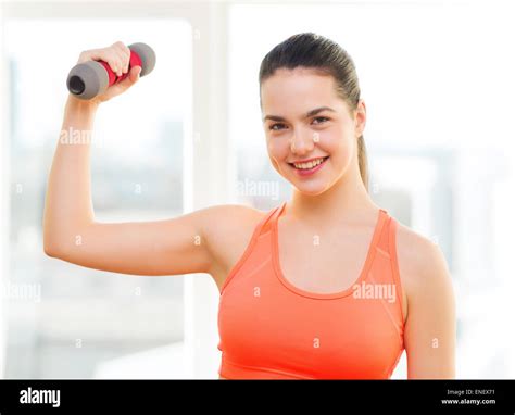 Smiling Teenage Girl Exercising With Dumbbell Stock Photo Alamy