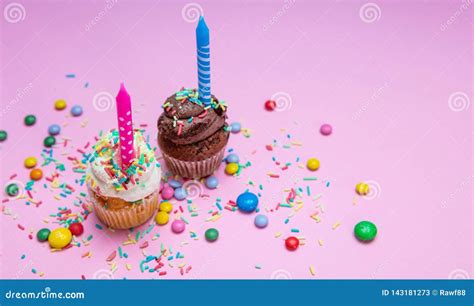 Two Birthday Cupcakes With Candles On Pink Pastel Background Copy