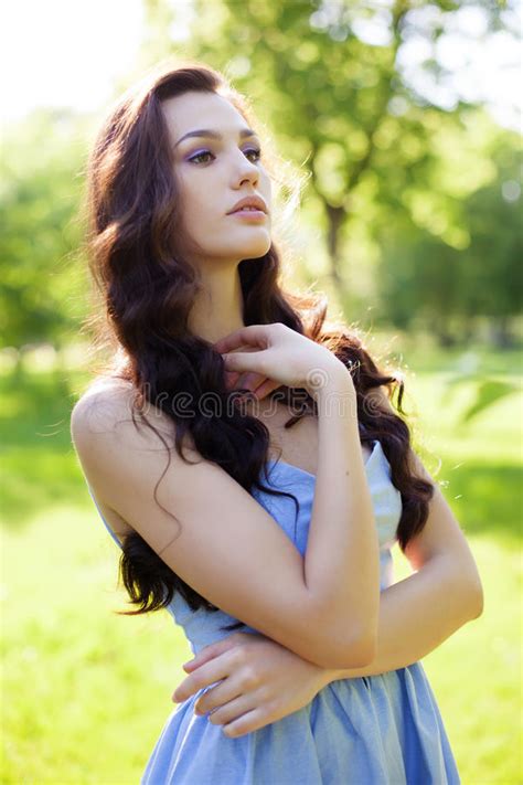 Portrait Of A Beautiful Young Caucasian Woman In A Spring Garden Stock