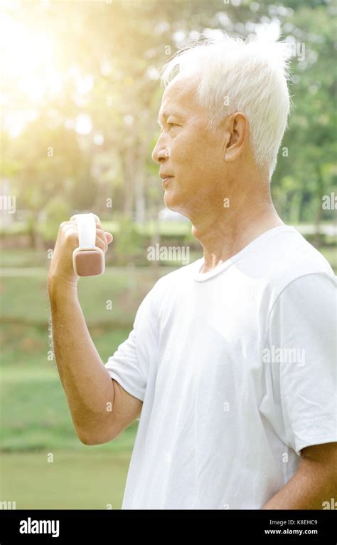 Portrait Of Active Healthy White Hair Asian Old Man Workout At Outdoor Park In Morning Stock