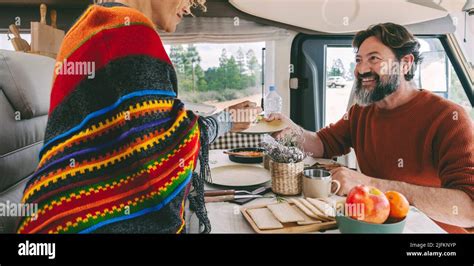 People In Travel Vacation Leisure Inside A Camper Van Enjoying Lunch Together Man And Woman