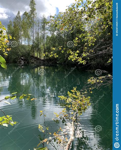 Lake With A Turquoise Water And Stone Shores Overgrown With Forest