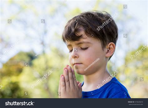 Closeup Boy Praying Eyes Closed Park Stock Photo 573645673