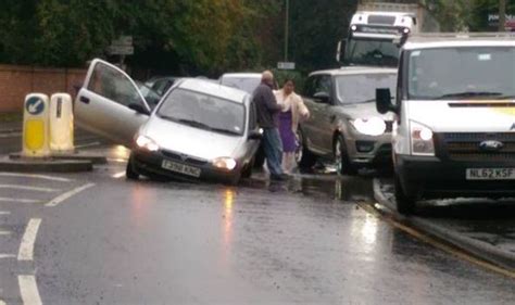 A Car Trying To Navigate A Puddle Gets Stuck In A Ft Deep Pothole Uk