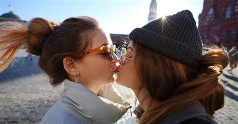 A Same Sex Couple Kissing Each Other While Wearing Sunglasses · Free