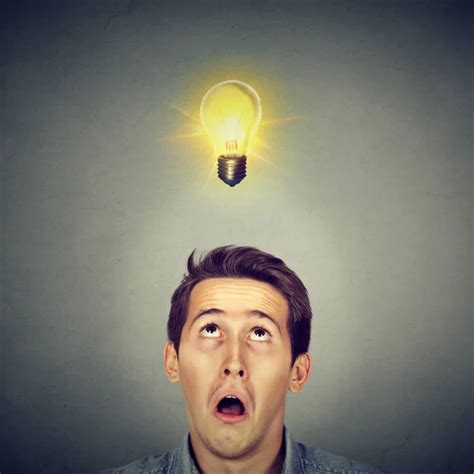 Thinking Man Looking Up With Light Idea Bulb Above Head Stock Photo By