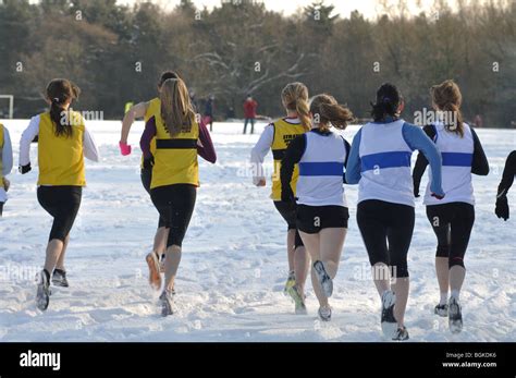 Teenage Girls Starting Cross Country Race In Snow Seen From Behind