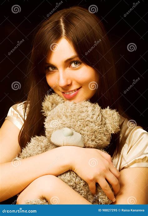 woman holding a teddy bear stock image image of happy 98827295