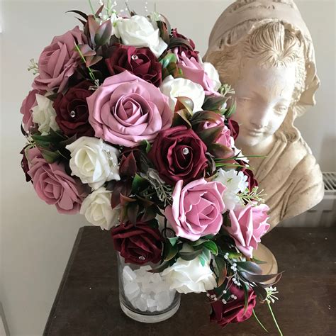 A Teardrop Bouquet Of Artificial Burgundy Ivory And Pink Foam Roses