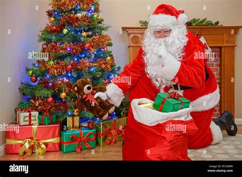 Santa Delivering Presents Under The Tree