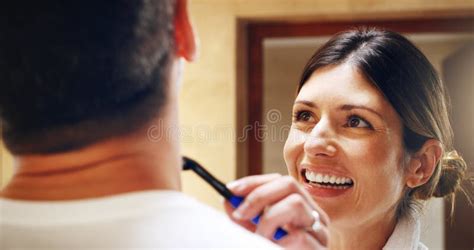 helping her man get a clean shave a woman shaving her husbands facial hair in the bathroom at
