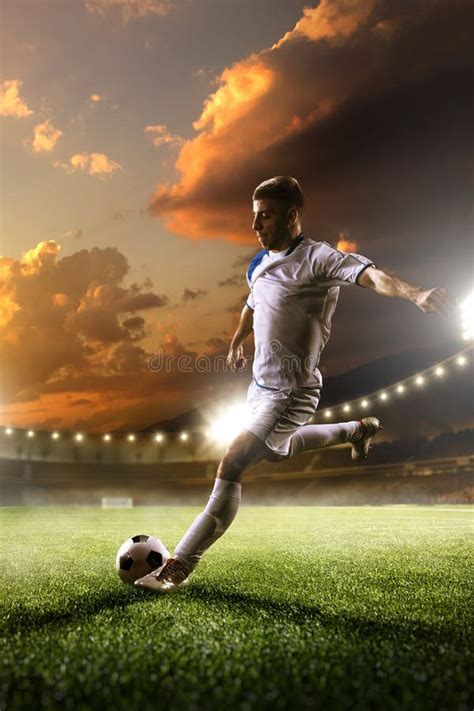 Soccer Player In Action On Sunset Stadium Background Stock Image