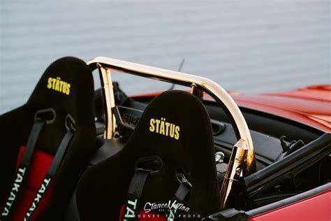 The Interior Of A Red Sports Car With Black Seats And Yellow Lettering