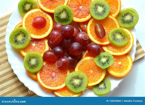 Fresh Sliced Fruits On A Plate Wood Background Stock Photo Image Of
