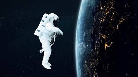 Premium Photo Spaceman Flies In Outer Space Near The Blue Planet Earth With Night Lights Of