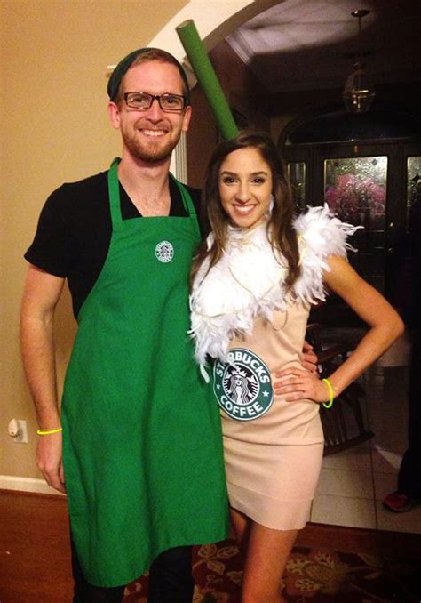 A Man And Woman Dressed Up In Green Aprons Posing For The Camera With Their Arms Around Each Other