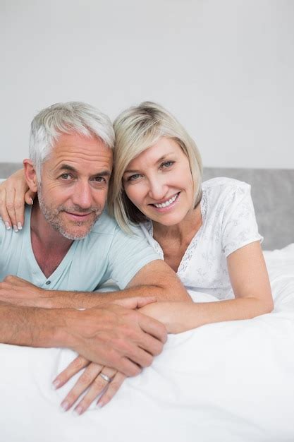 Premium Photo Portrait Of A Mature Couple Lying In Bed