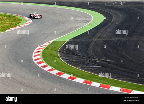 Formula One Race Car Speeding Through S Curve On Racetrack Stock Photo