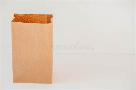 Open Disposable Package Made Of Brown Kraft Paper On A White Background