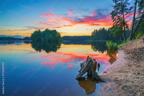 Beautiful Landscape With Corful Sunset Over The Forest Lake Stock Photo