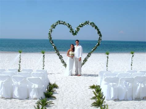 A heart drawn in the sand, with both names in the heart. Beach Wedding Arch Ideas - Beach Wedding Tips