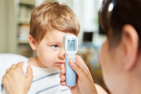 Pediatrician Measuring A Fever On A Child Stock Photo Image Of