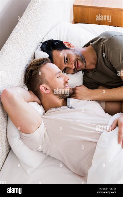 Happy Gay Couple Lying On Bed Stock Photo Alamy