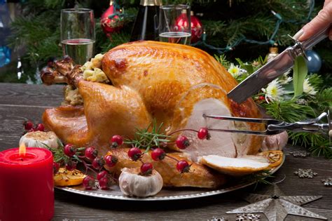 Carving Rustic Style Roasted Christmas Turkey Garnished With Roasted