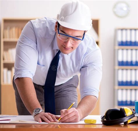 Engineer Supervisor Working On Drawings In The Office Stock Photo