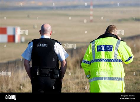 Two Police Officers Patrolling The Airport Perimeter At Manchester