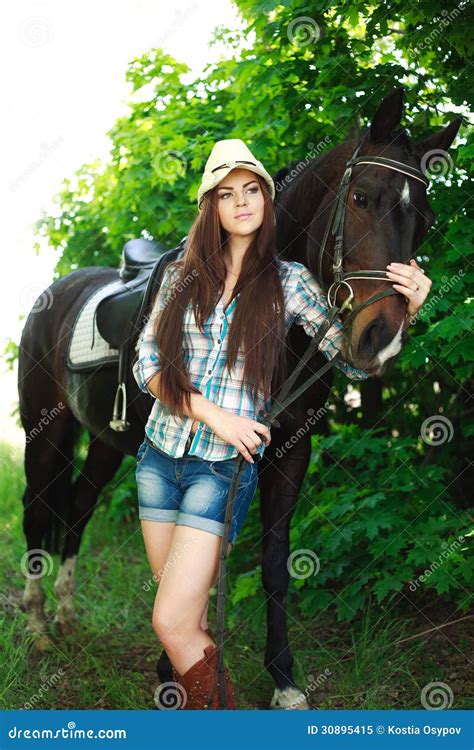 Outdoor Portrait Of Beautiful Cowgirl With Horse In Green Royalty Free