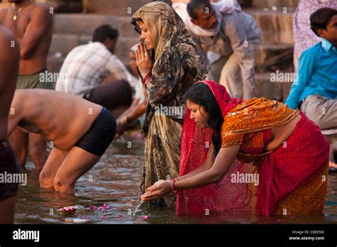 indian hindu pilgrim bathing and praying in the ganges river at dashashwamedh ghat in holy city