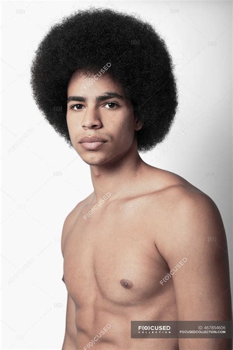Young Confident Black Man With Six Pack Abs And Afro Hairstyle Looking