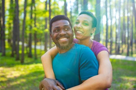 African American Couple Talking Together In Summer Park Stock Image