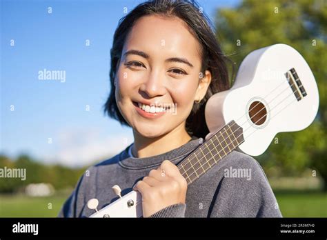 Portrait Of Beautiful Smiling Girl With Ukulele Asian Woman With