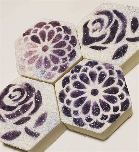 Four Purple And White Coasters Sitting On Top Of Each Other In The