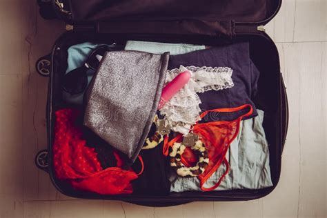 Traveling With Sex Toys Concept Packing Sex Toys In Luggage Suitcase When Going On Trip Stock